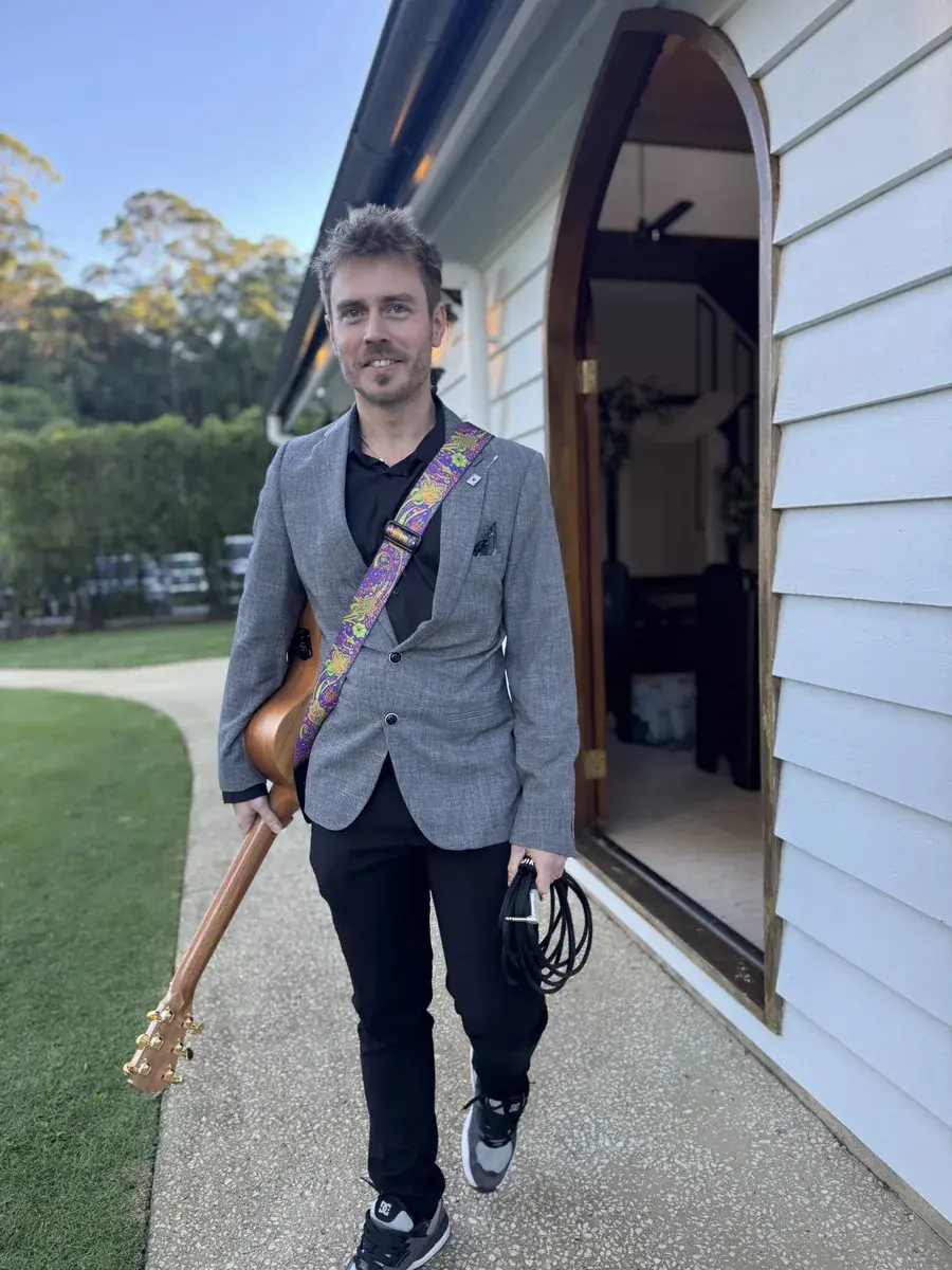 Damien Hill with his guitar after playing at a friend's wedding