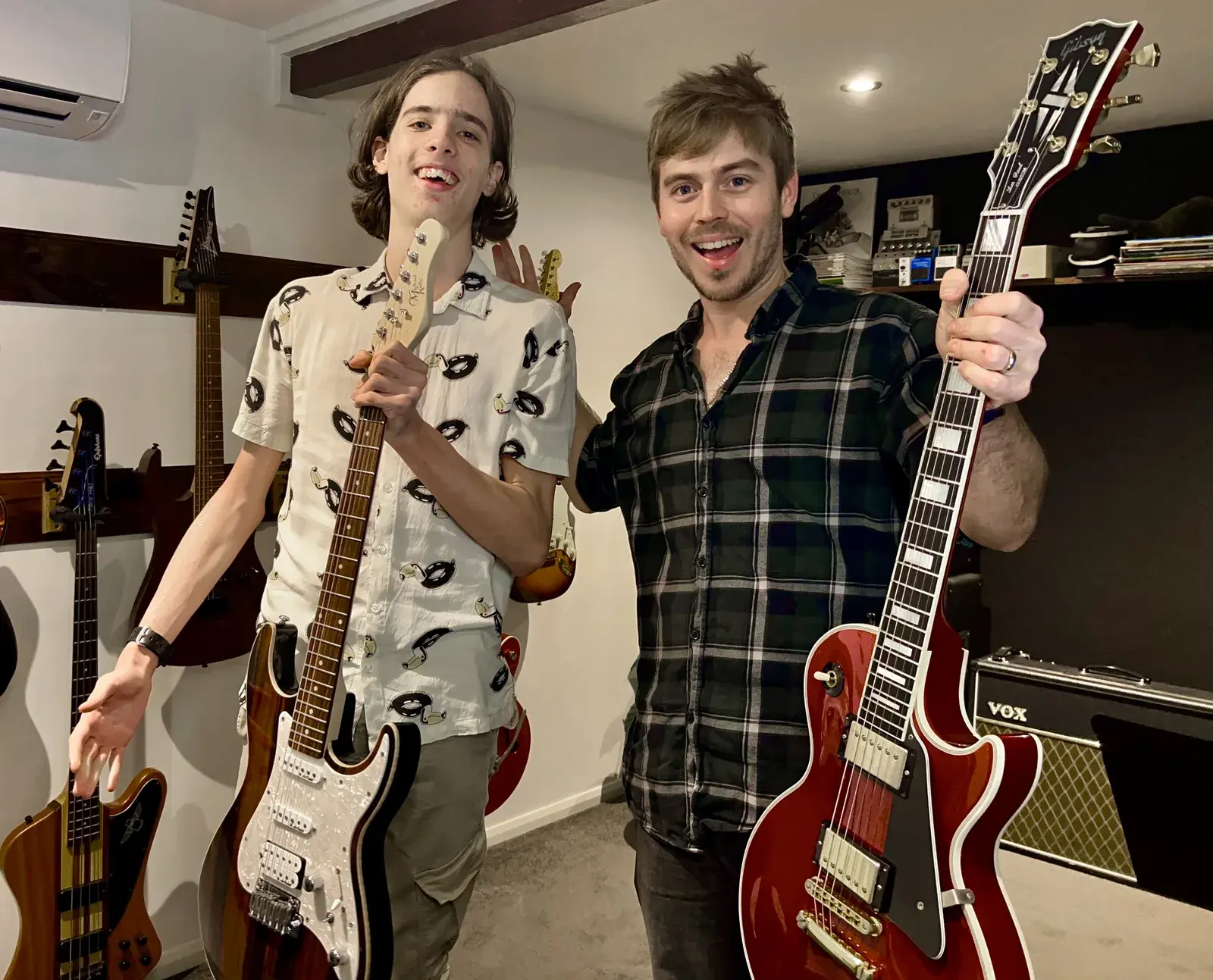 Damien Hill teaching a guitar lesson to a teenage student in a Six Strings Townsville studio in Kirwan